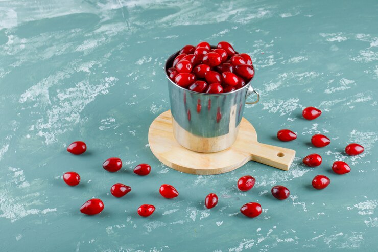 Free Photo cornel berries in a bucket on plaster and cutting board. high angle view.