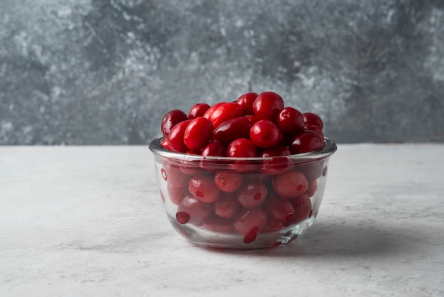 Free photo cornel berries in a glass cup.