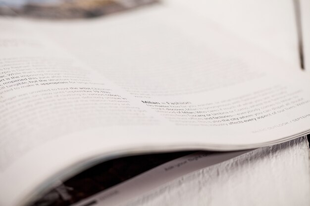 Corner of a magazine on a white table