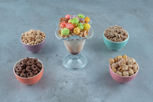 Cornflakes in a milk coffee glass and bowls , on the blue background. High quality photo