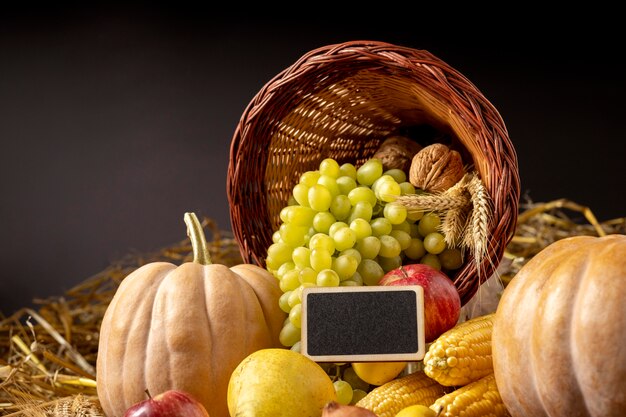 Cornucopia arrangement with delicious foods and empty blackboard