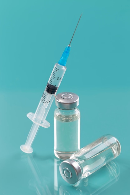 Coronavirus arrangement with vaccine bottle and syringe