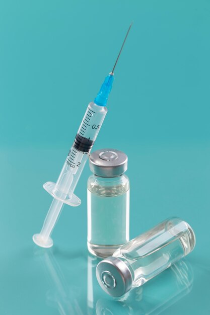 ワクチンボトルと注射器を備えたコロナウイルスの配置