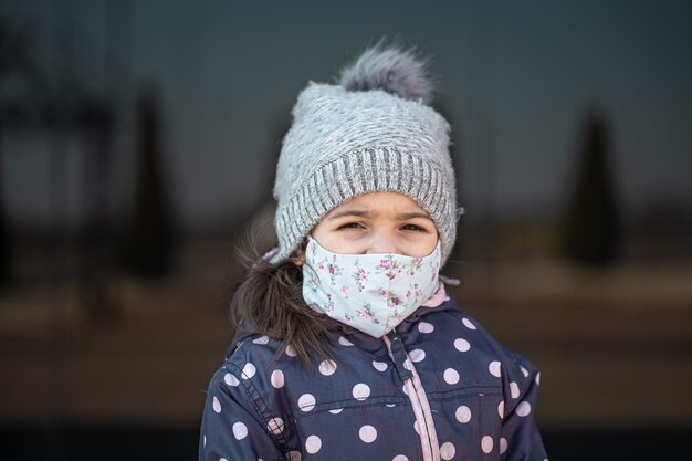 Coronavirus concept .A little girl wears a mask on her face during a virus epidemic