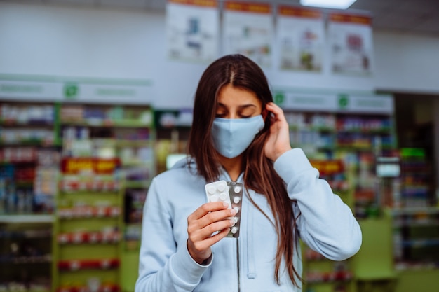 Coronavirus. Covid-19. Woman takes and shows pills, vitamins or pills in his hand. vitamins or pills. Health and treatment concept.