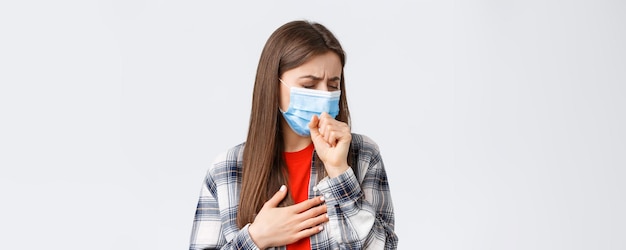 Free photo coronavirus outbreak leisure on quarantine social distancing and emotions concept closeup of sick young woman in medical mask staying at home during covid19 cough with closed eyes