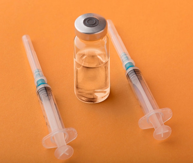 Free photo coronavirus vaccine assortment on orange