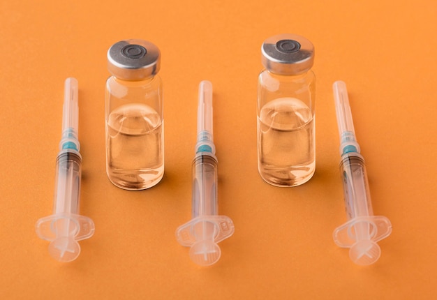 Coronavirus vaccine assortment on orange