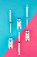 Free photo coronavirus vaccine vials and syringes arrangement