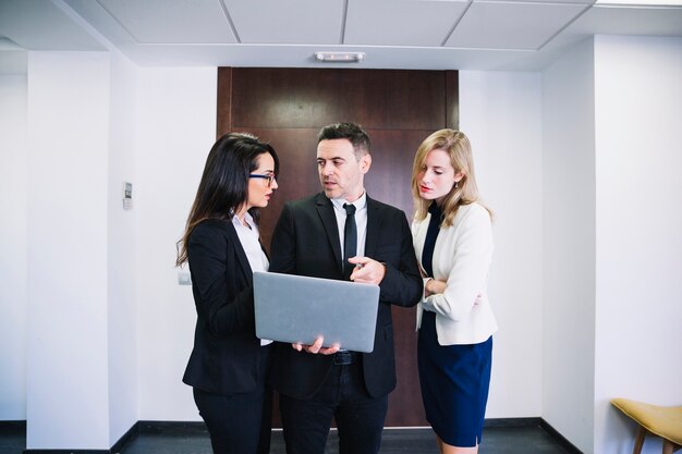 Corporate business people holding laptop