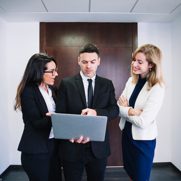 Corporate business people looking at laptop