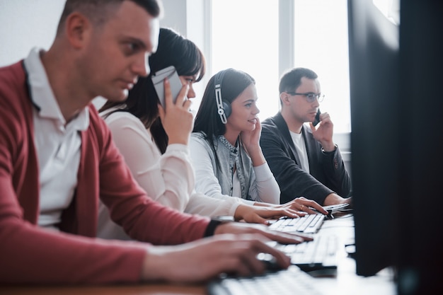 Corporate business. Young people working in the call center. New deals is coming