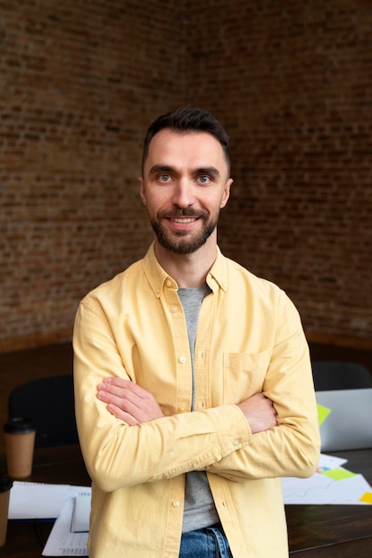 Free photo corporate employee posing at the office