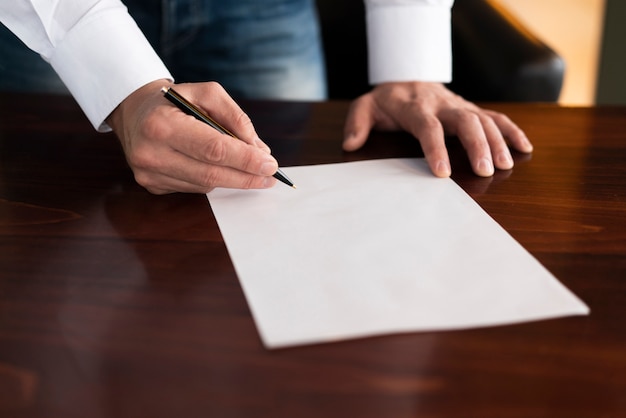 Corporate employee writing on blank paper