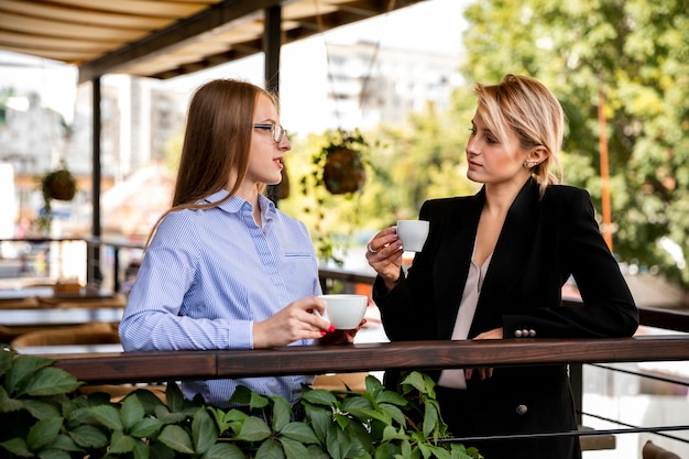 Corporate employees talking and drinking coffee