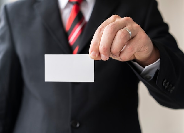 Corporate man holding blank business card