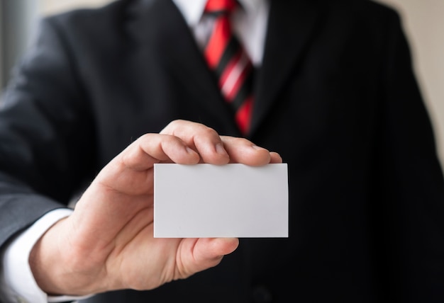 Corporate man holding blank business card