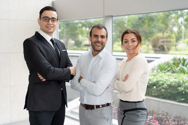 Corporate portrait of three members of successful business team