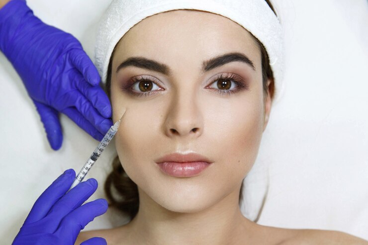 Free Photo cosmetologist makes beauty injection in woman's face in the clinic