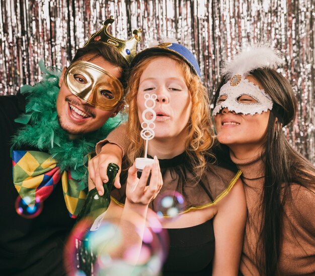 Costumed friends having fun at carnival party