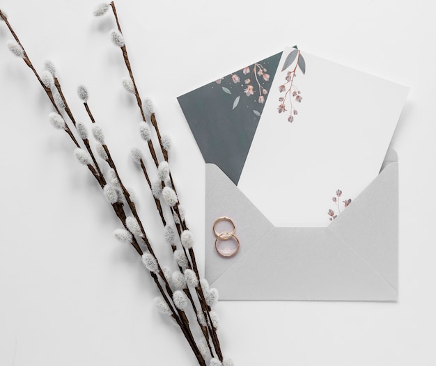 Cotton branch beside wedding invitation