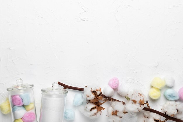 Cotton branch and jars on table