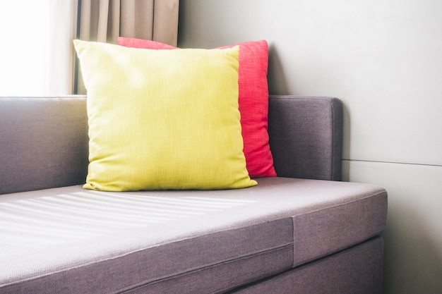 Couch with yellow and pink cushions