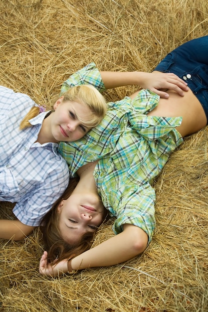 country girls restings on hay