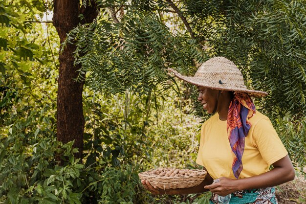 Countryside woman holding basket with peanuts