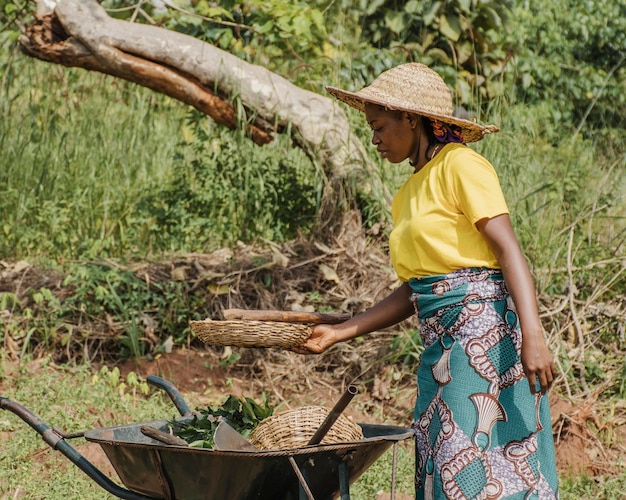 Countryside woman next to a wheelbarrow