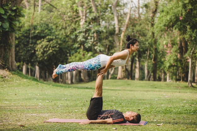 Couple of acrobats training in the nature