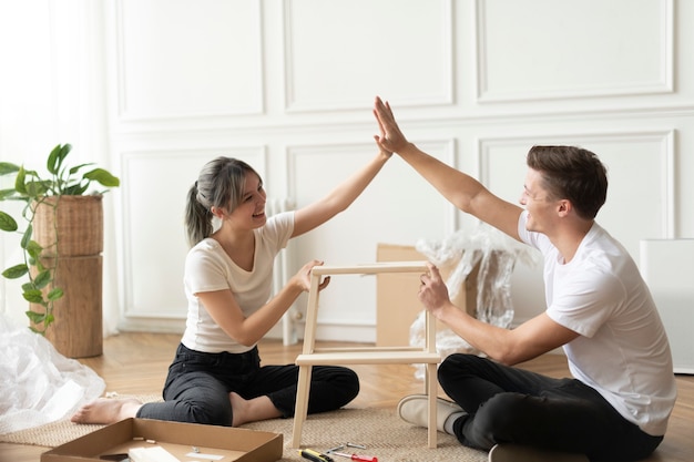 Free photo couple assembling a diy chair from scratch