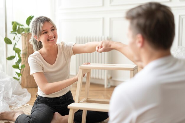 Couple assembling a diy chair from scratch