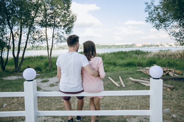 Couple of backs sitting on a white fence