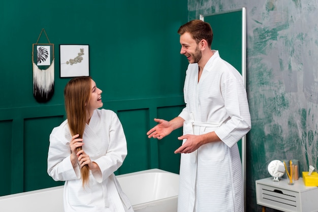 Couple in bathrobes looking at each other