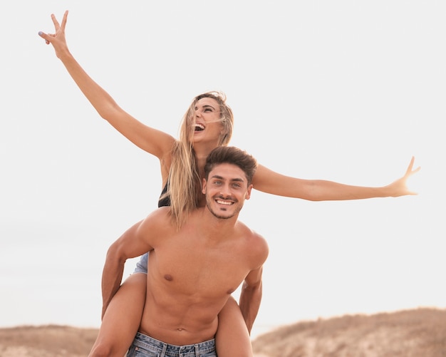 Free photo couple at beach playful moment