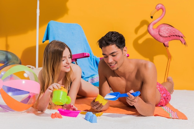 Couple on beach playing with toys