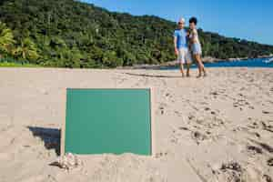 Free photo couple at the beach with slate