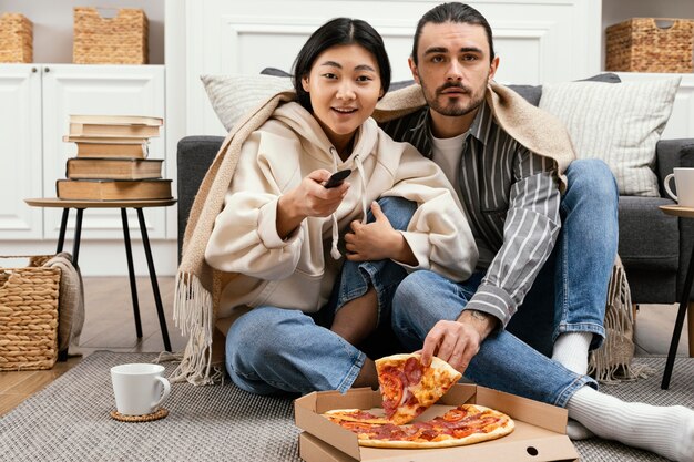 Couple in blanket watching a movie