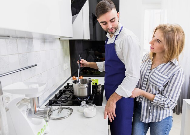 Couple boiling water in pot