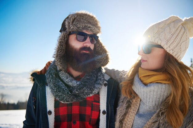 Couple and bright sun behind them