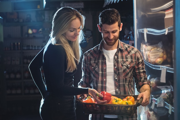 Couple buying vegetables in organic shop