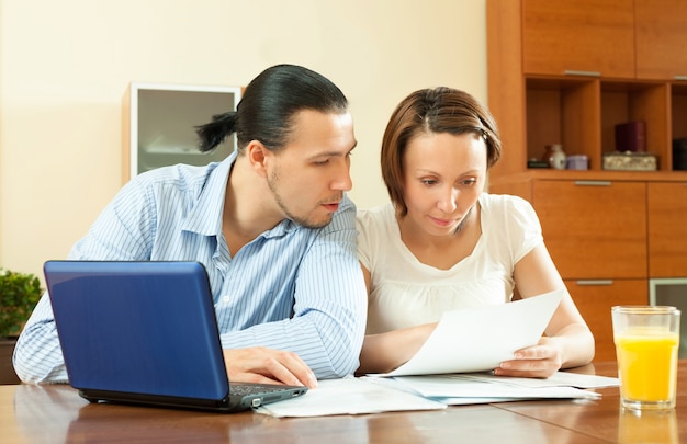 Free photo couple calculating family budge