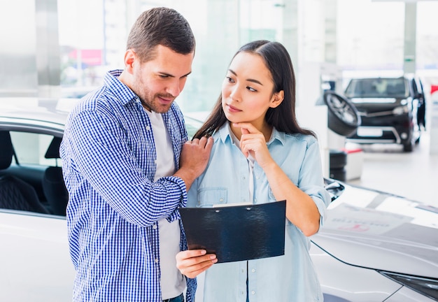 Couple in car dealership