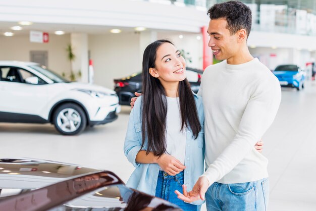 Free photo couple in car dealership