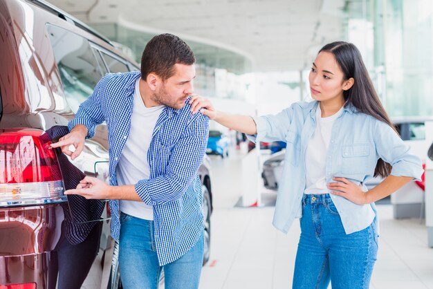 Couple in car dealership