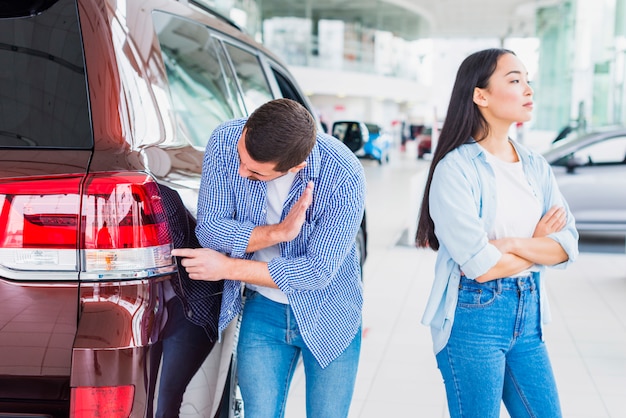 Couple in car dealership