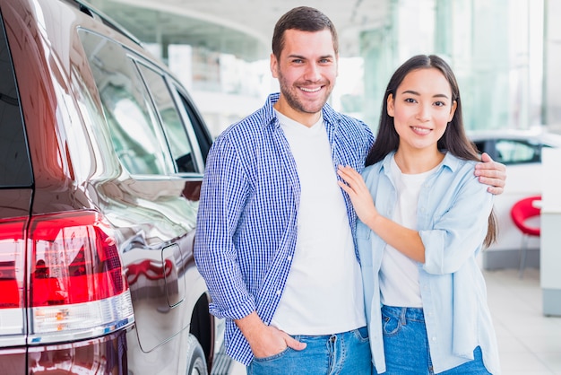 Couple in car dealership