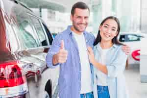 Free photo couple in car dealership