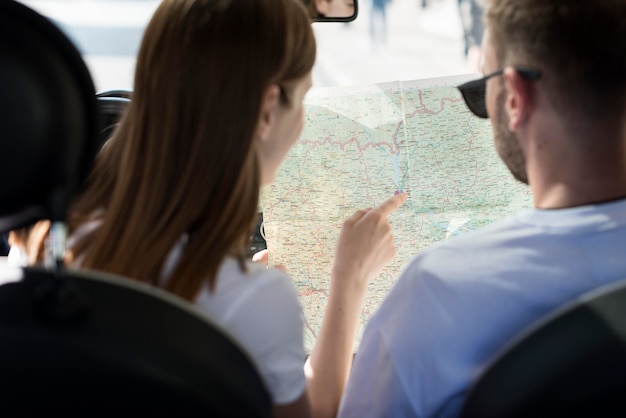 Couple in the car looking at map